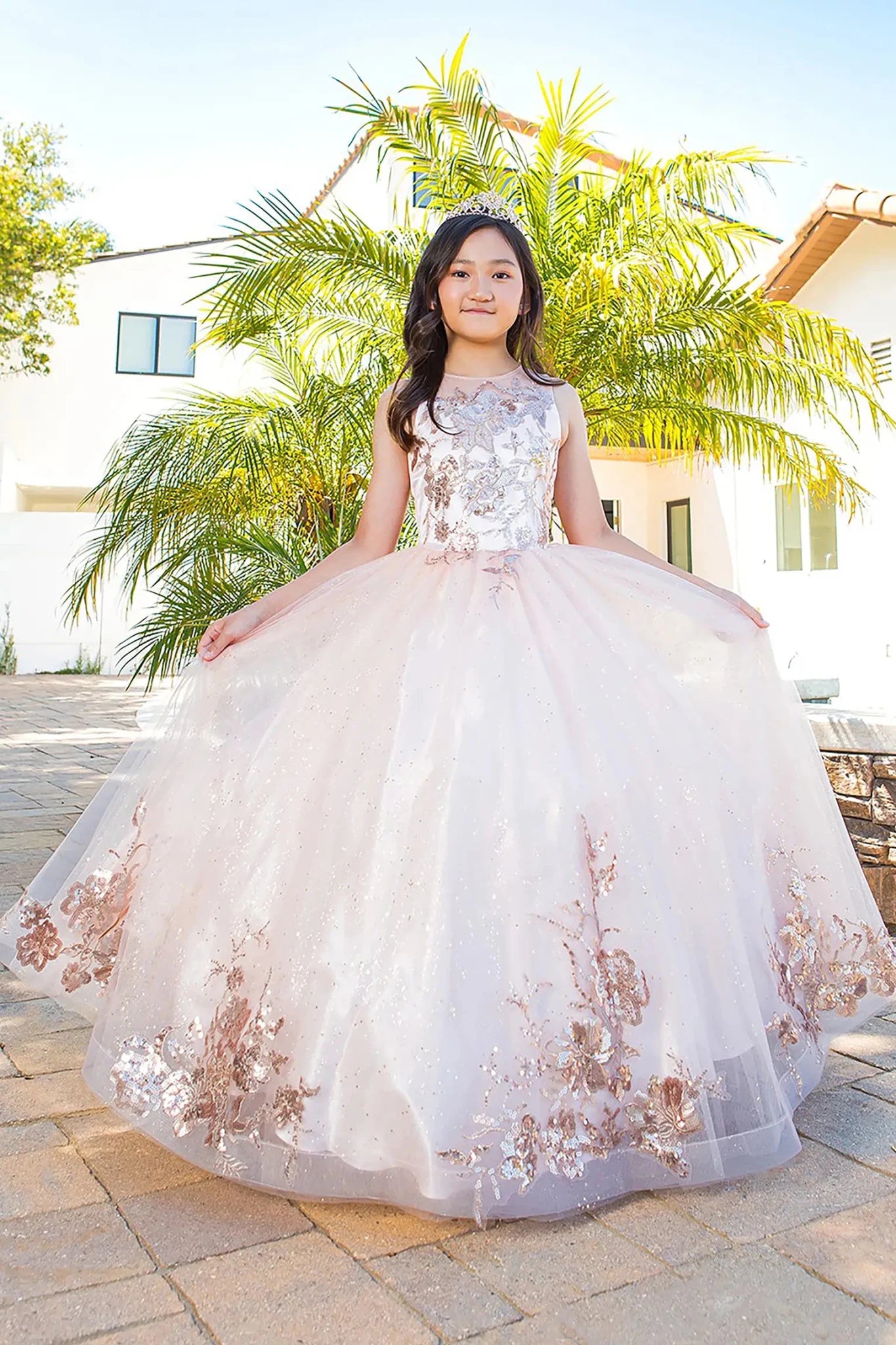 Front view of blush mini quince dress with glitter tulle fitted bodice and voluminous layered skirt.