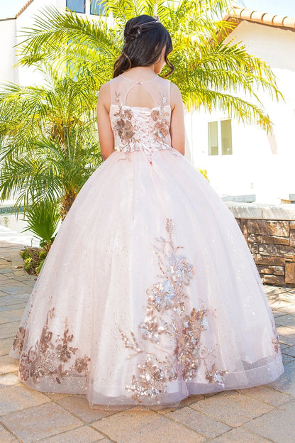 Displayed in a back view, the Blush mini quince dress has lace-up back and floral appliques across the tulle skirt.