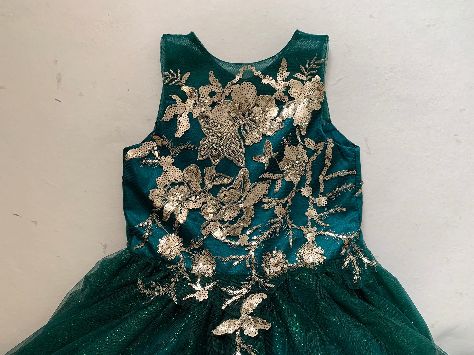Kid wearing hunter green mini quince dress with glitter tulle bodice top zoom detail