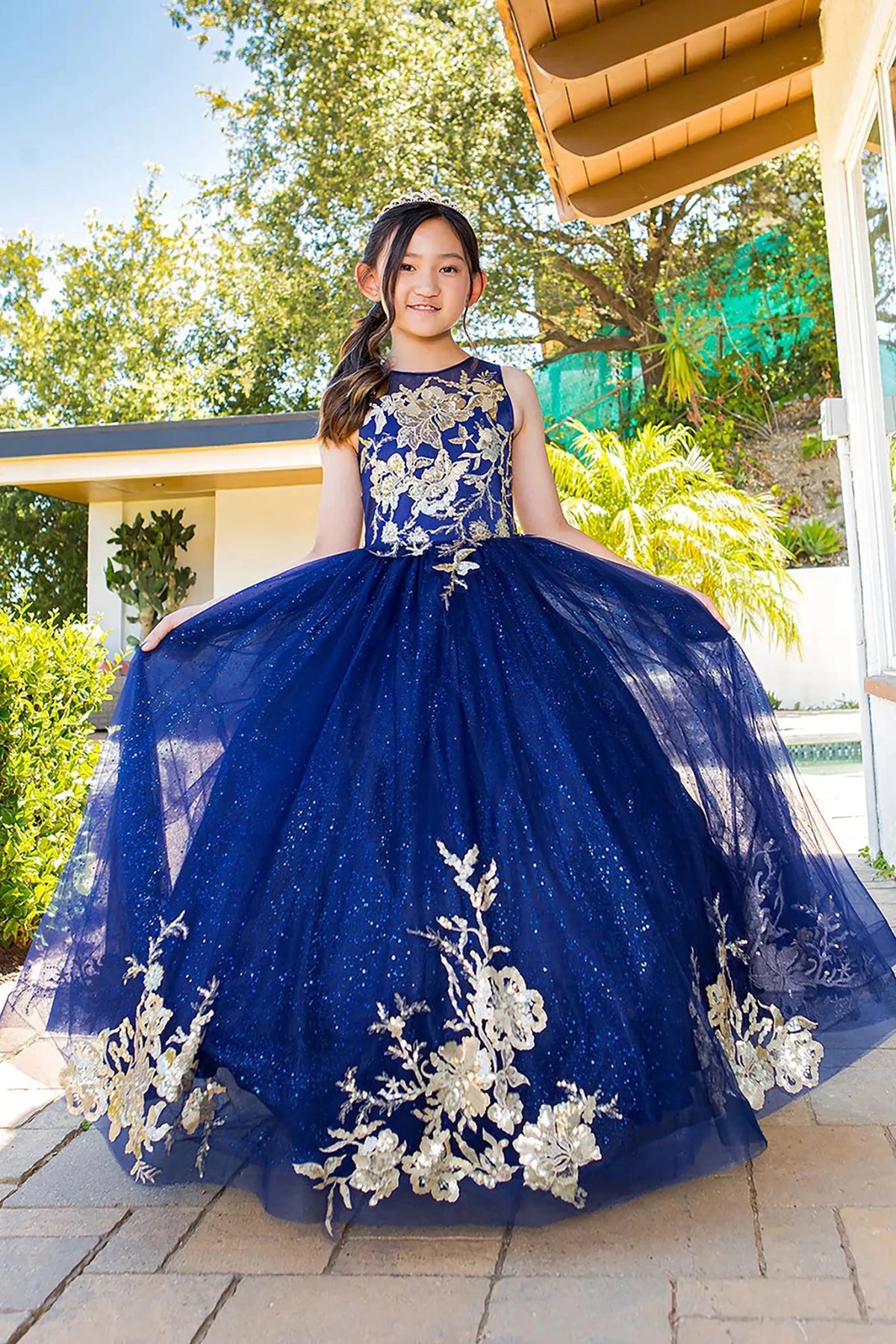 Front view of navy mini quince dress with glitter tulle fitted bodice and layered skirt.