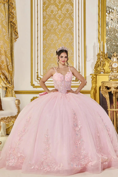 Woman in a pink ball gown standing in an opulent room with gold decor.