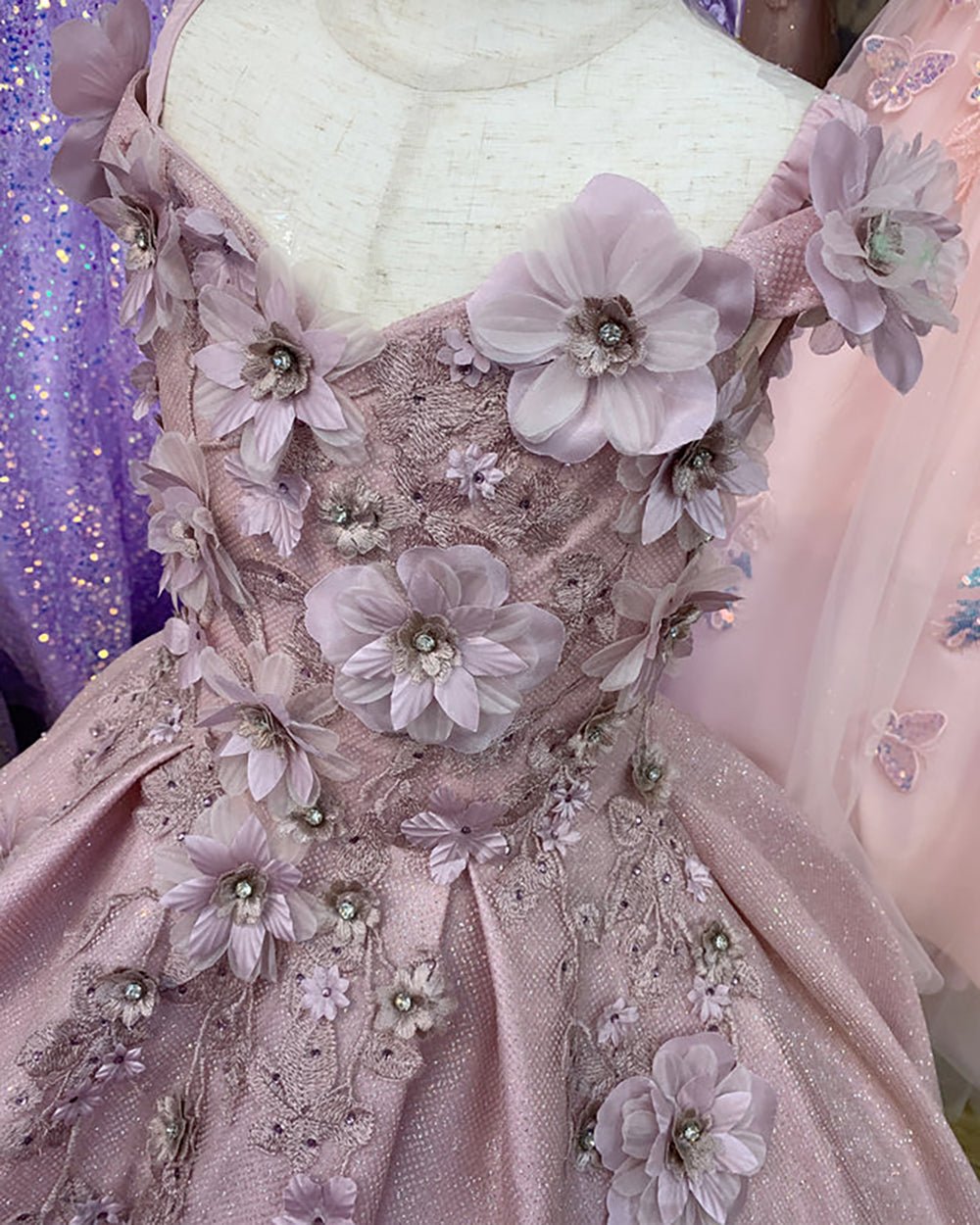 showing the top of the flower girl dress with flowers.