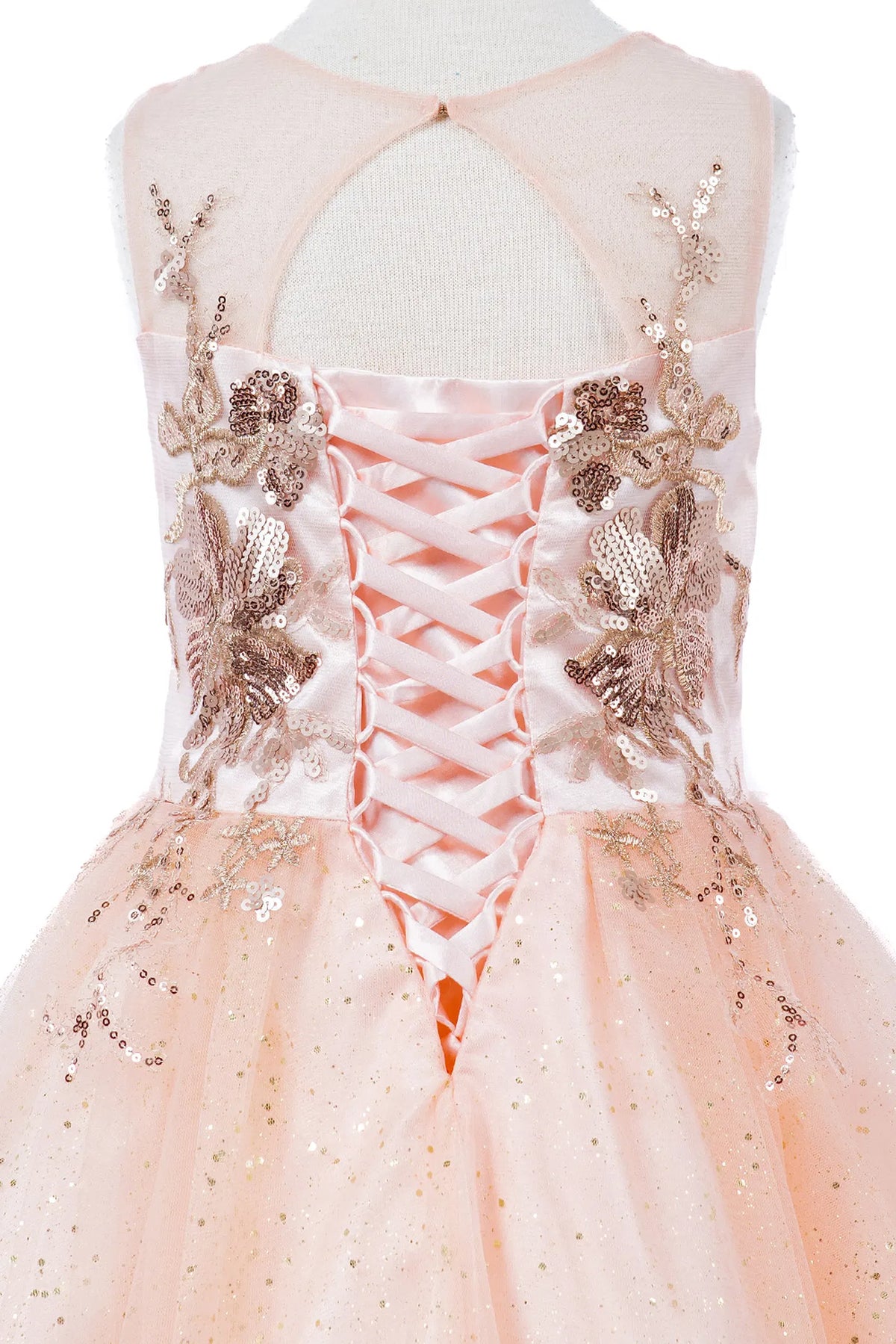 Detailed by a lace-decorated back bodice, the Blush kids party dress reveals its construction.