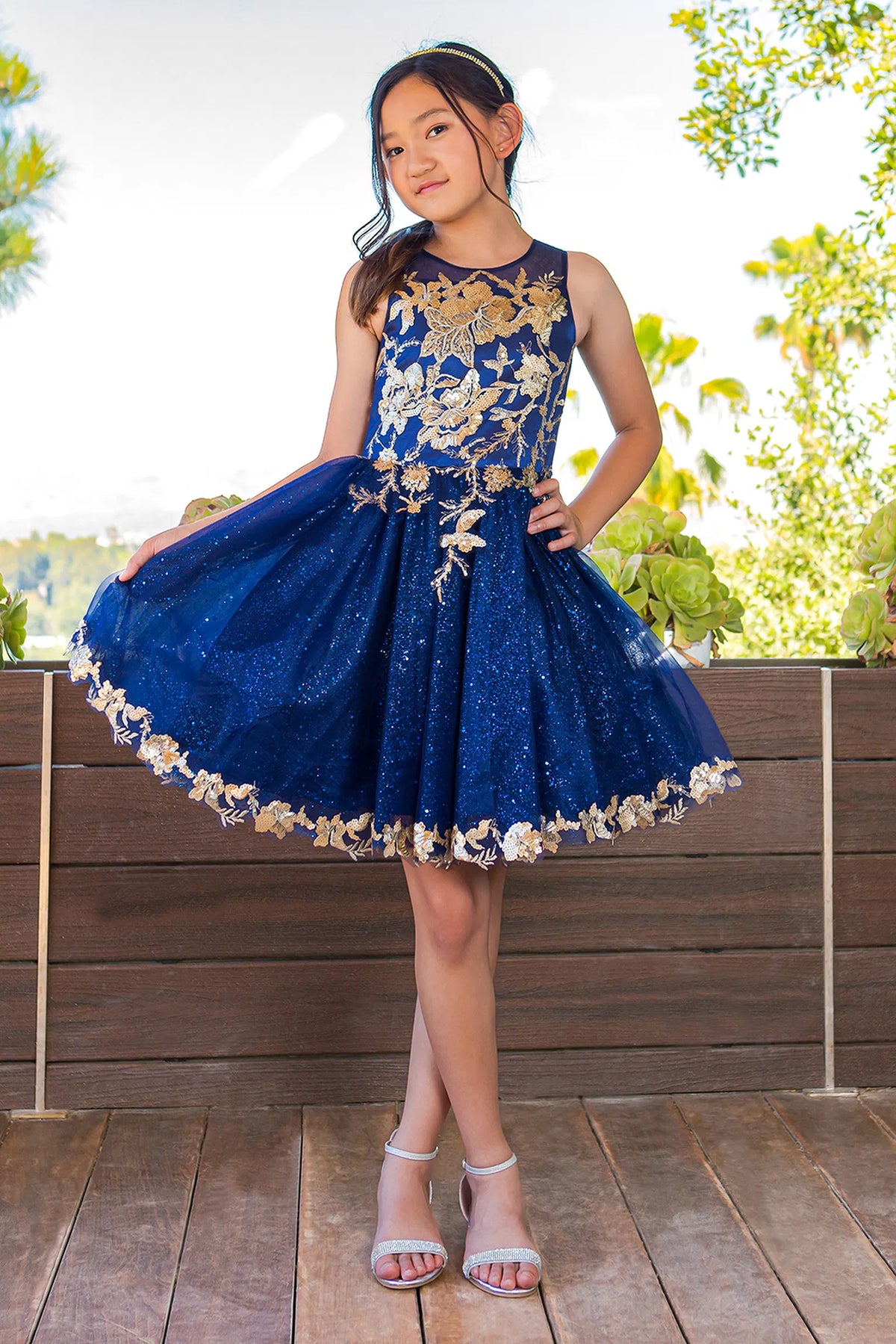 Framed contrasting floral lace appliques adds character to this Navy kids party dress.