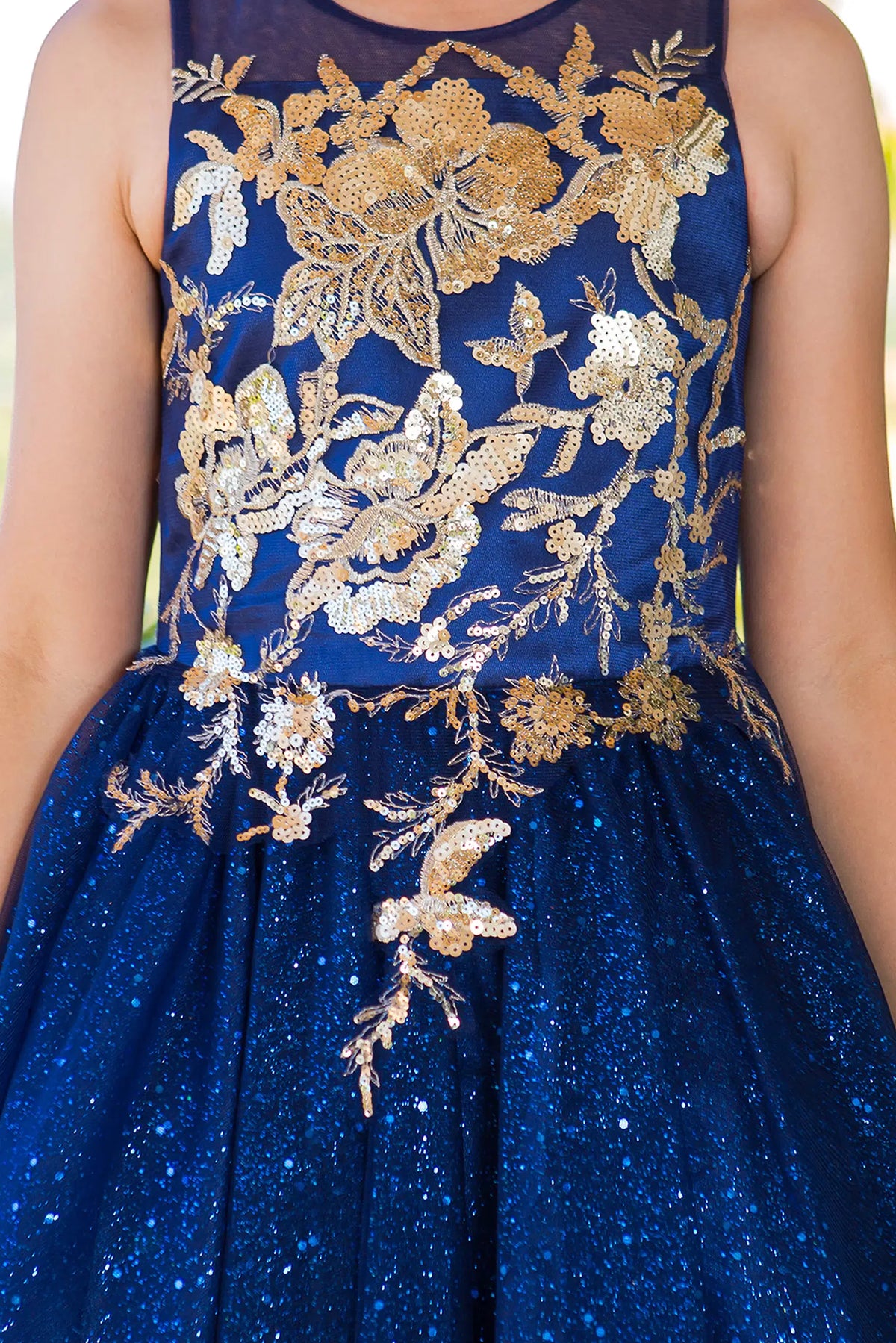 Designed details of contrasting floral lace appliques distinguish the Navy kids party dress.