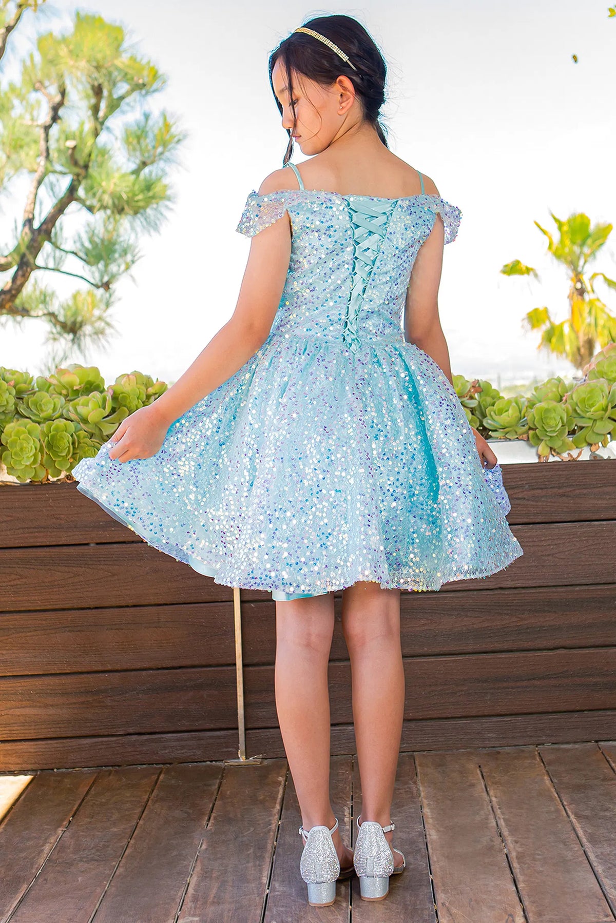 Finished details of crisscross back lacing distinguish the Blue kids party dress.