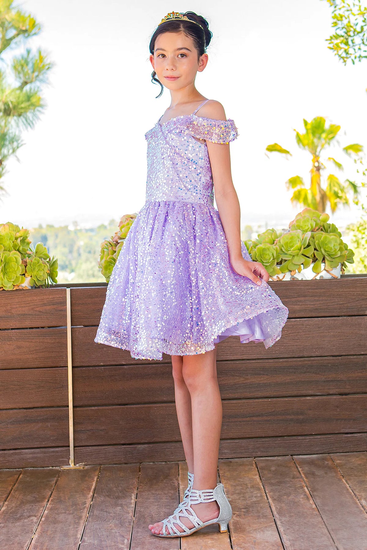 Styled with a laced back bodice, this Lilac kids party dress displays elegant detail.