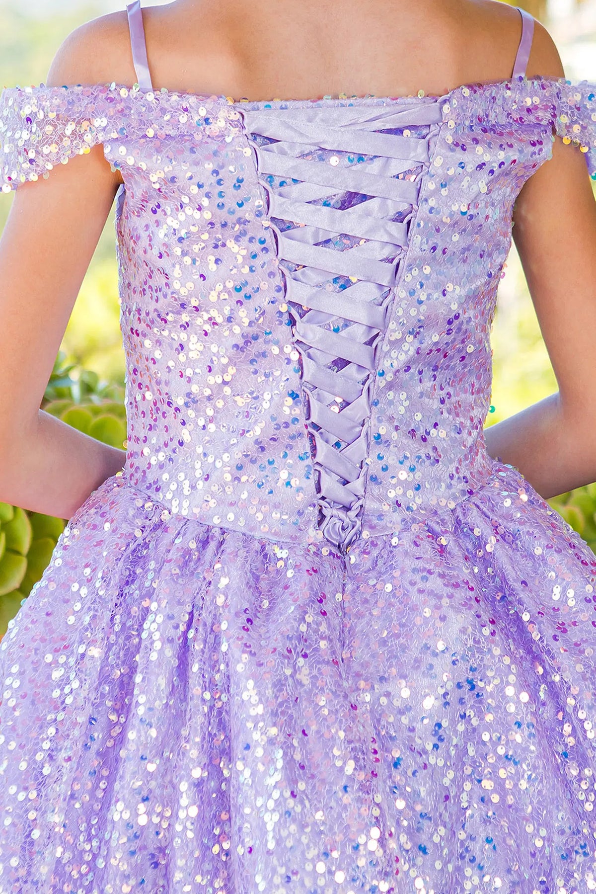 Detailed by crisscross back lacing, the Lilac kids party dress reveals its construction.