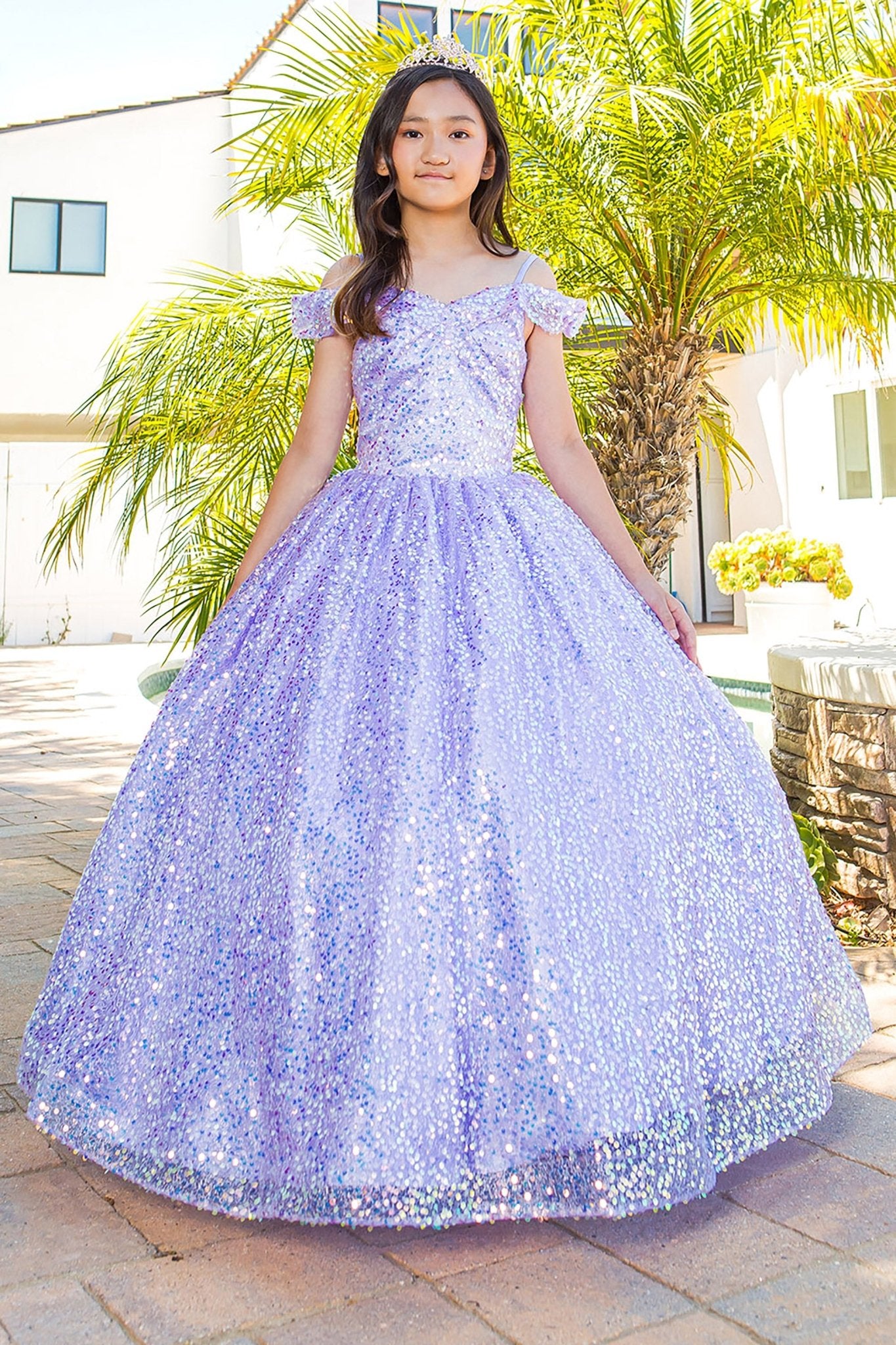 Front view of a kid wearing pink mini quince dress with glitter tulle 3D flower puff print and A-line skirt
