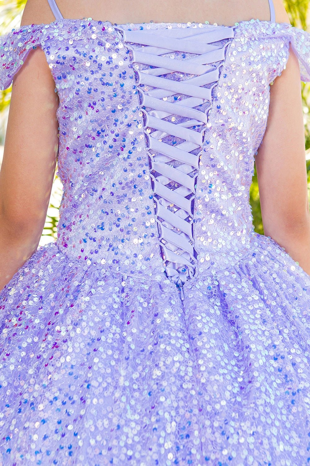 Displayed in a back detail, the Lilac mini quince dress has lace-up back framed by sparkling sequins.