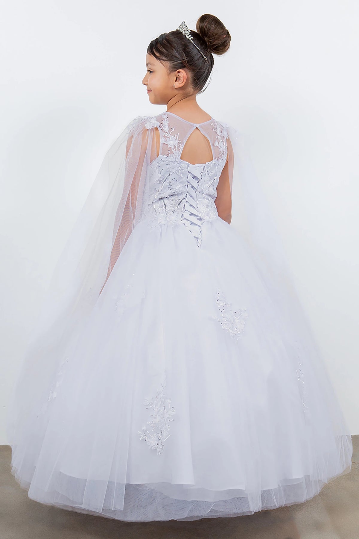 A white lace flower girl dress with a cape.