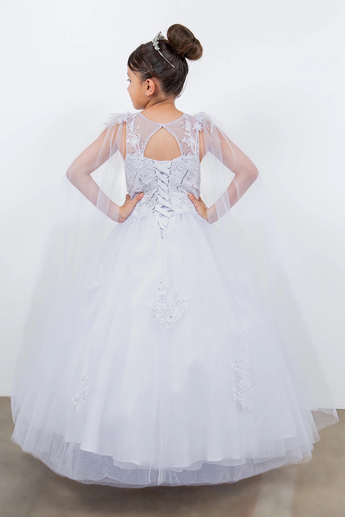 A white lace flower girl dress with sheer sleeves.