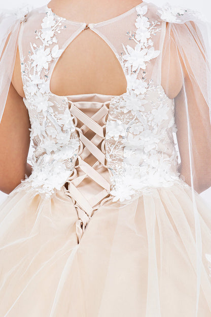 champagne kid ball gown with intricate lace detailing and a soft tulle skirt.