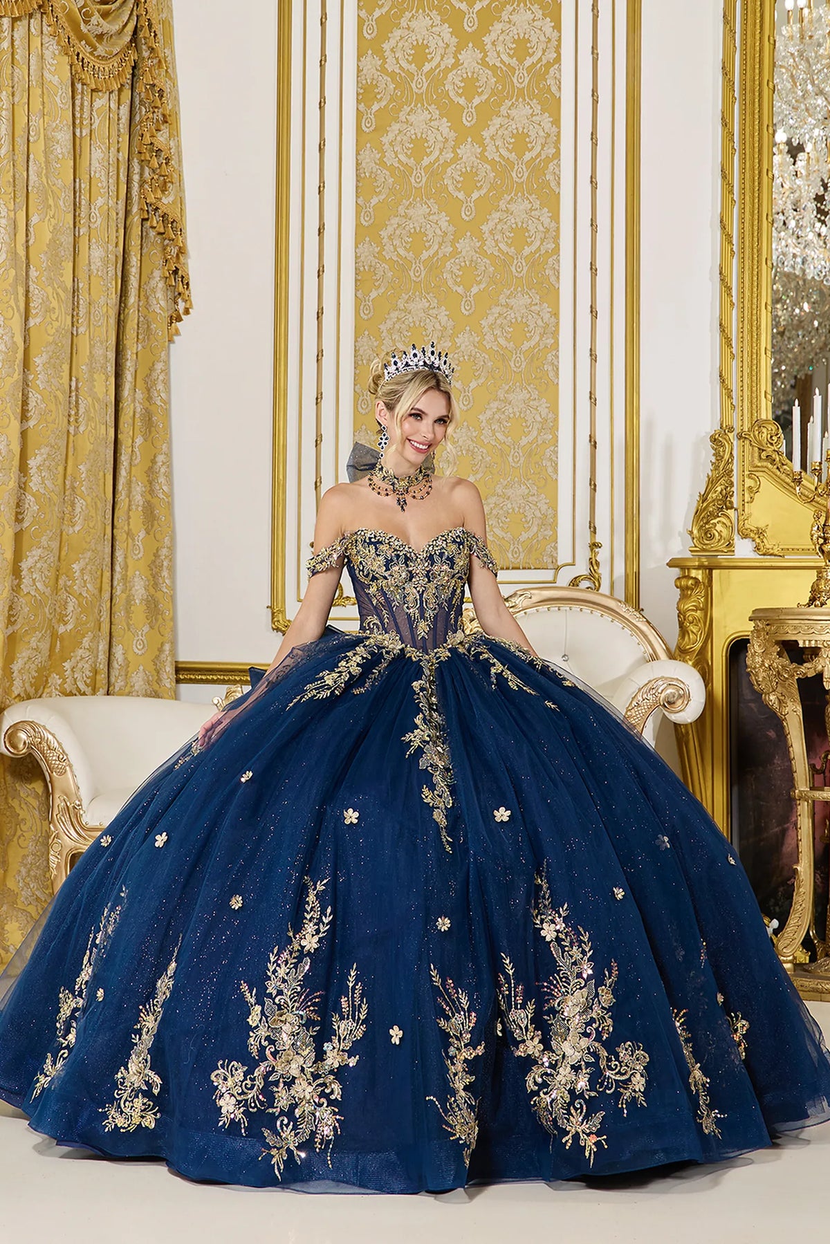 Front view of a Navy quinceañera gown with off-the-shoulder neckline, corset bodice, floral embroidery, and glitter tulle skirt