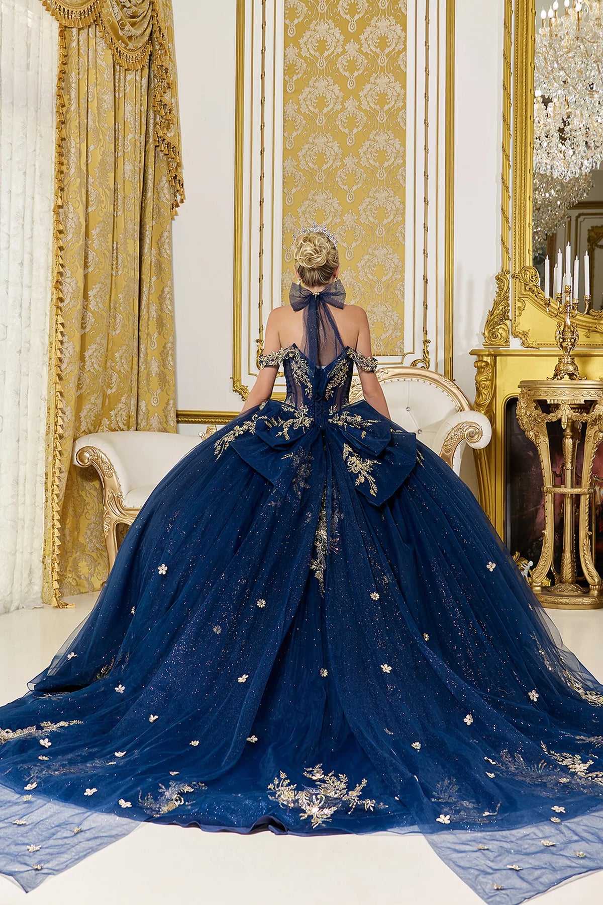 Back view of a Navy quinceañera gown showing lace-up back, glitter tulle skirt, and floral embroidery