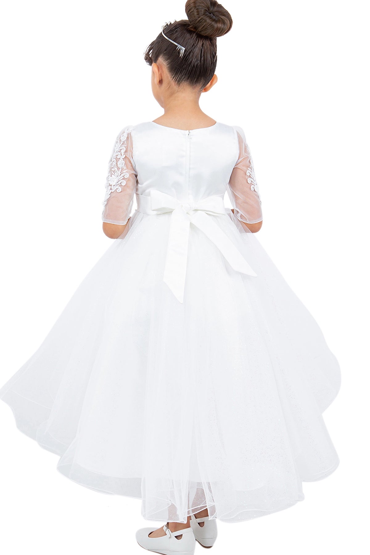A Off-White flower girl dress showing large back bow above the layered skirt.