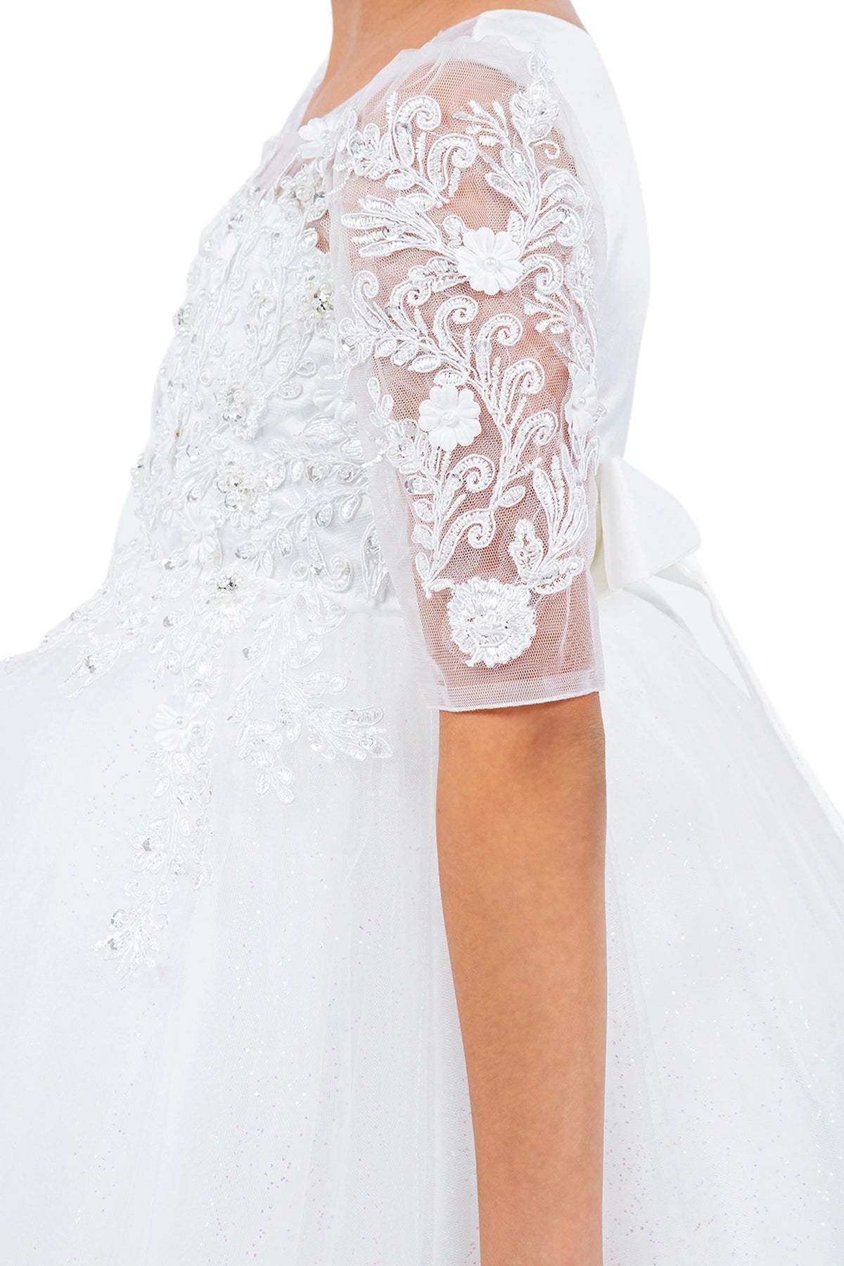 Details of the Off-White flower girl dress include floral lace covering the sheer sleeves.