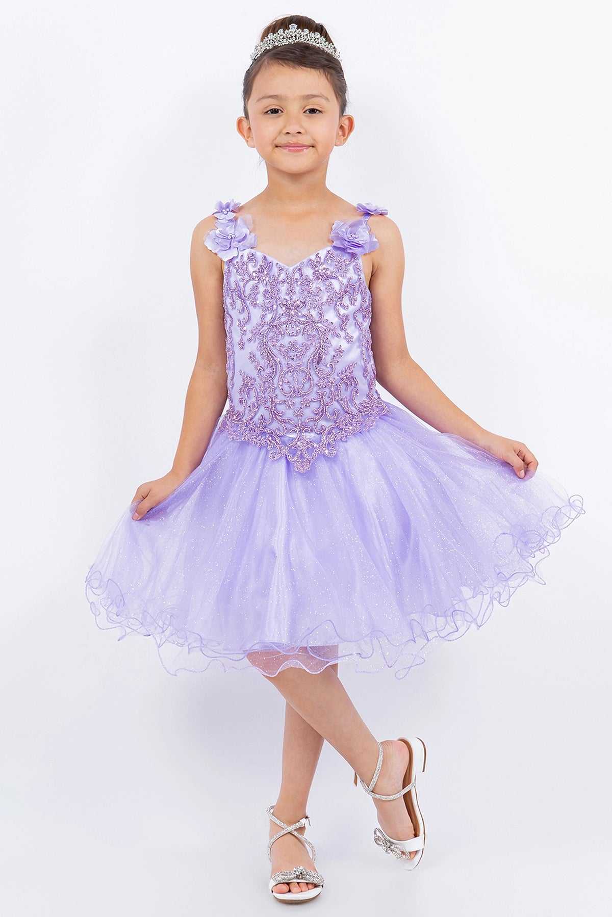 Showcasing with dimensional flowers along the straps, this Lilac kids party dress displays elegant detail.