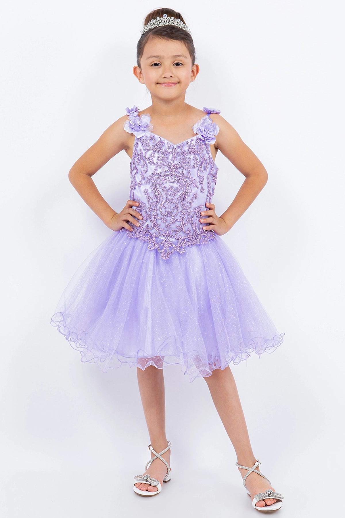 Detailed by a lacy floral bodice, the Lilac kids party dress reveals its construction.