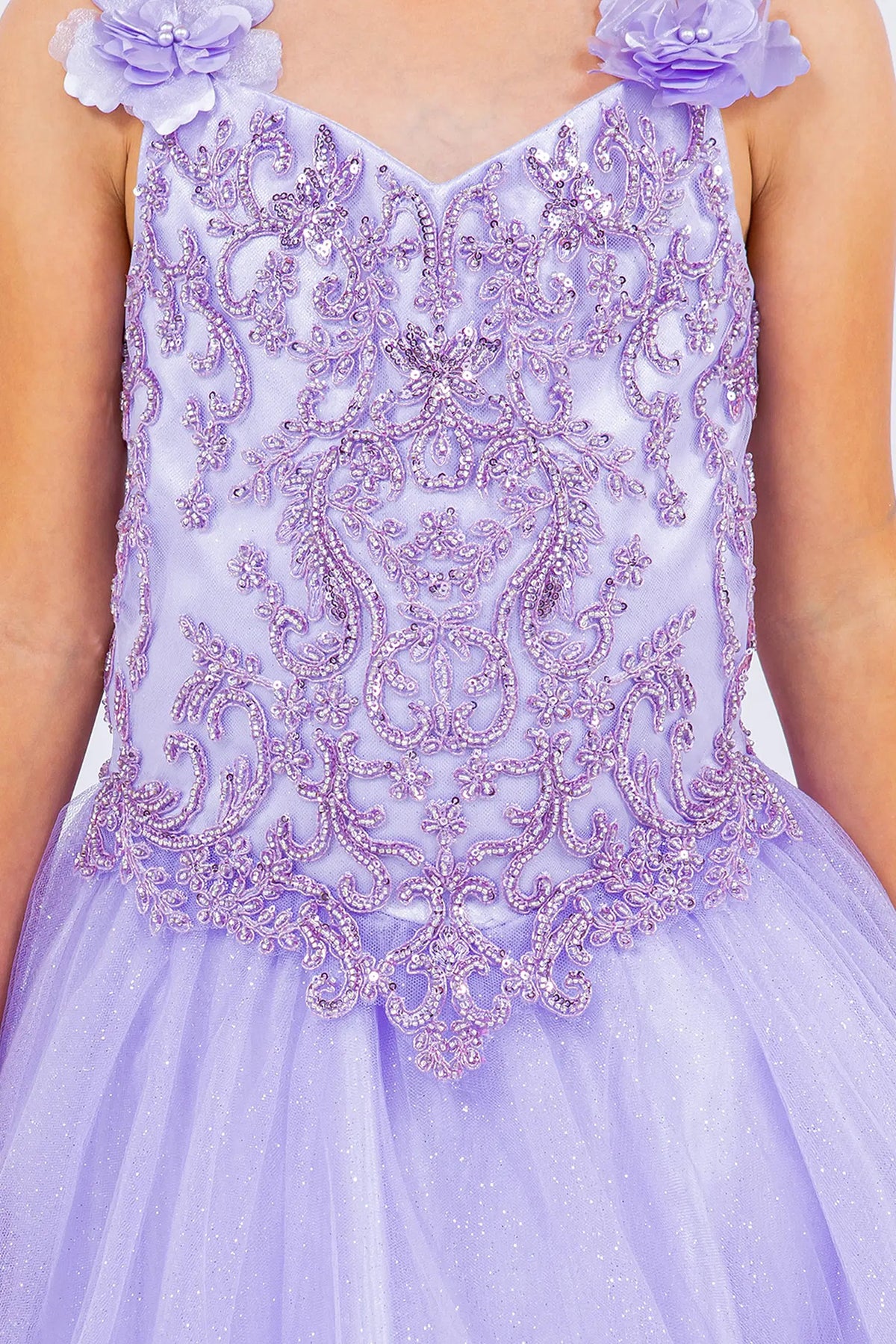 Finished details of dimensional flowers along the straps distinguish the Lilac kids party dress.