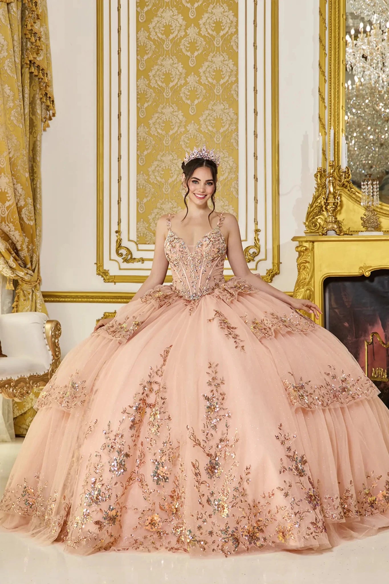 Front view of rose gold quinceañera ball gown with puff sleeves, embellished sweetheart corset bodice, and layered tulle skirt featuring floral embroidery and glitter accents.