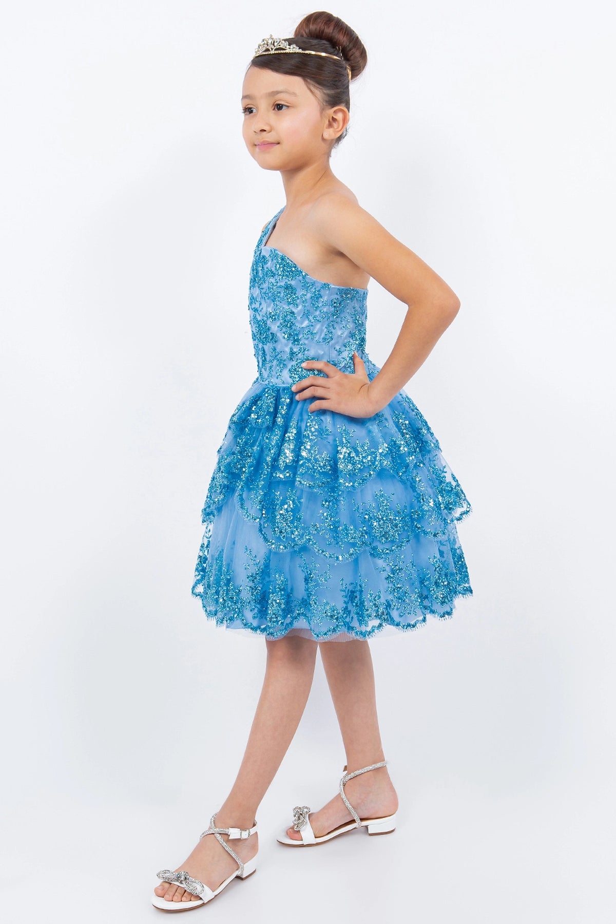Trimmed by a tiered ruffled skirt, the Blue kids party dress reveals its construction.