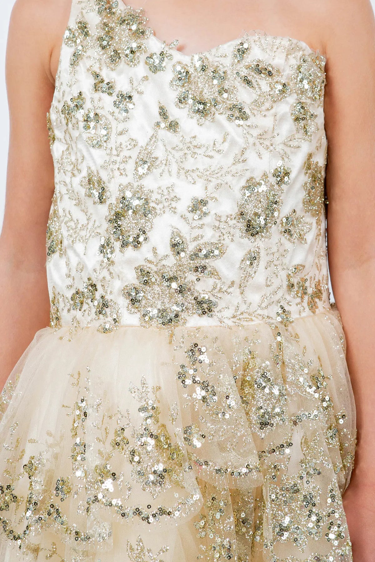 Accented a tiered ruffled skirt adds character to this Champagne kids party dress.