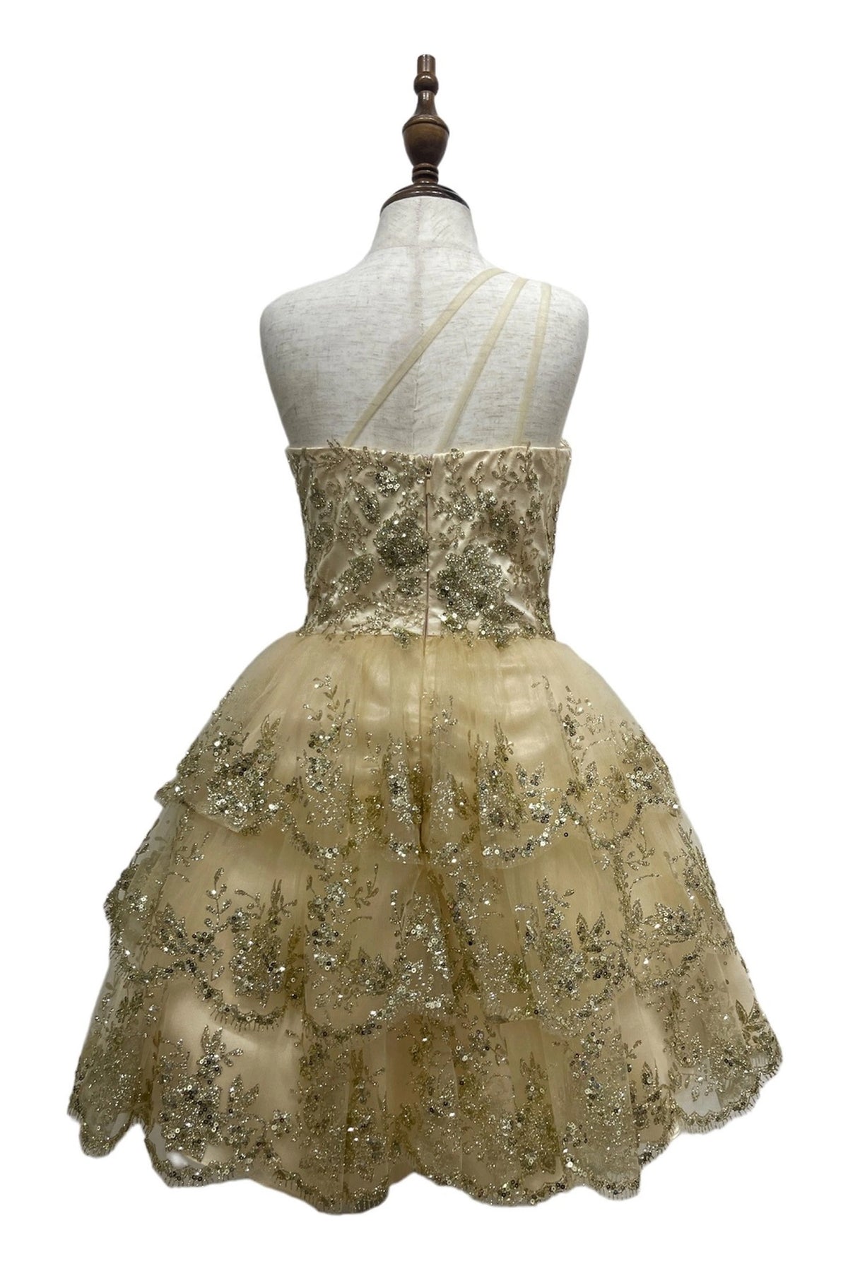 Styled with a tiered ruffled skirt, this Champagne kids party dress displays elegant detail.