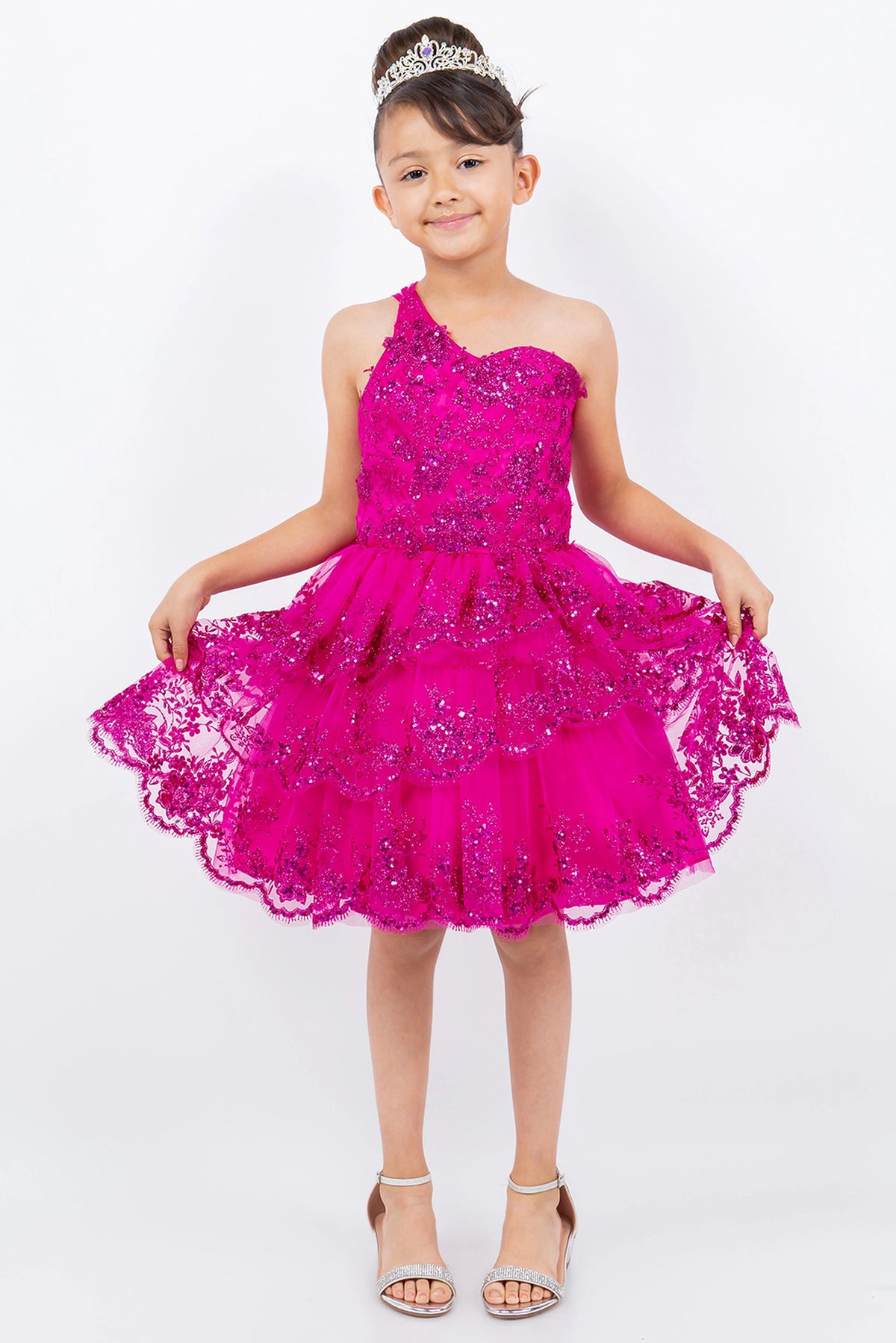 Showcasing with a tiered ruffled skirt, this Fuchsia kids party dress displays elegant detail.