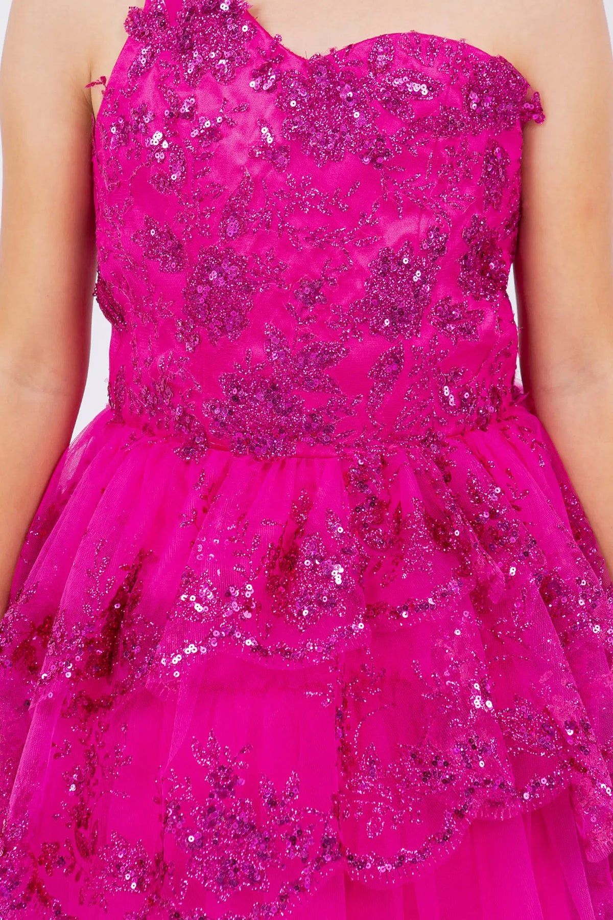 Featuring with a tiered ruffled skirt, this Fuchsia kids party dress displays elegant detail.