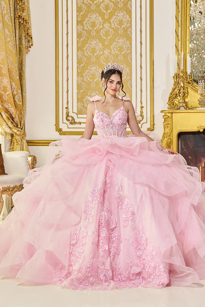Front view of pink quinceañera ball gown with sweetheart corset bodice, delicate shoulder bows, layered ruffle tulle overskirt, and floral applique detailing