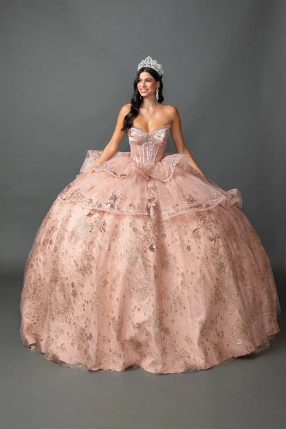 Woman in Rose gold strapless quinceañera ball gown with beaded corset and layered tulle skirt.