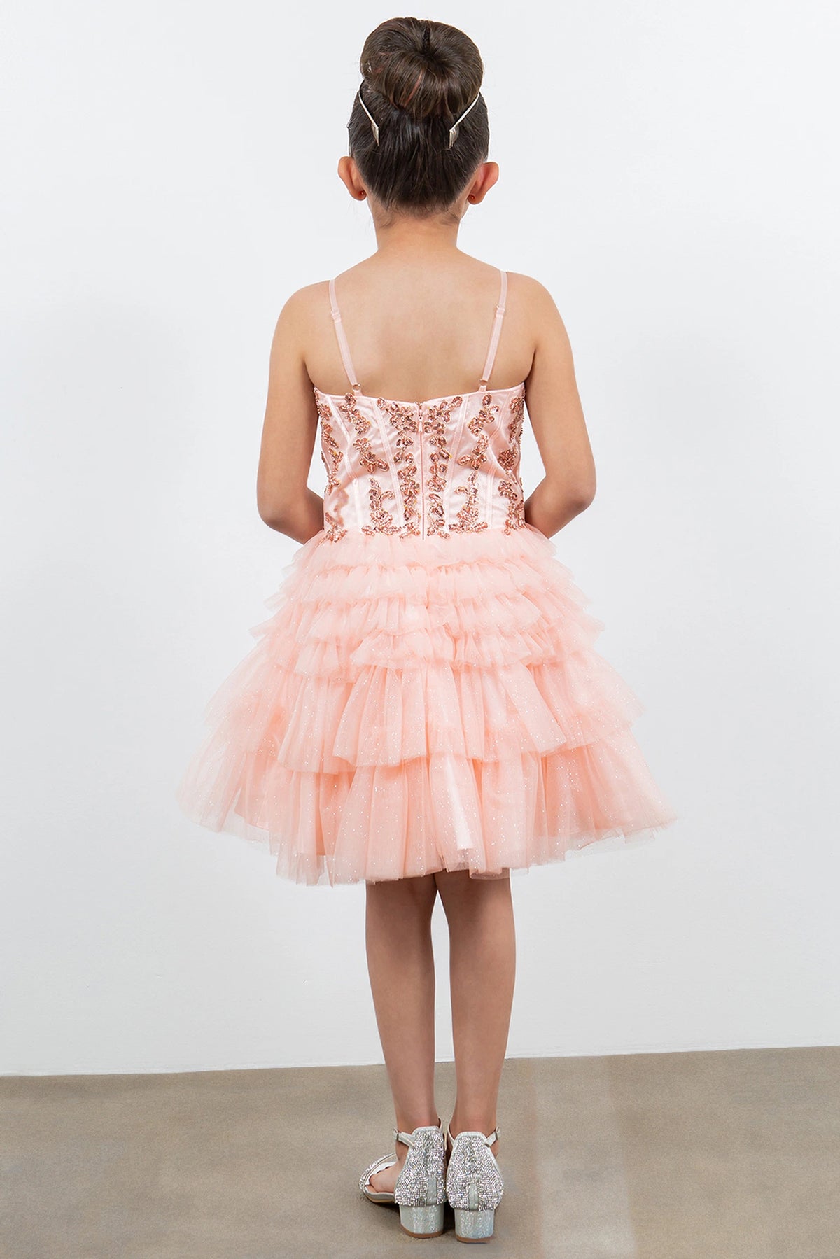 Finished details of a straight back and tiered ruffles distinguish the Blush kids party dress.