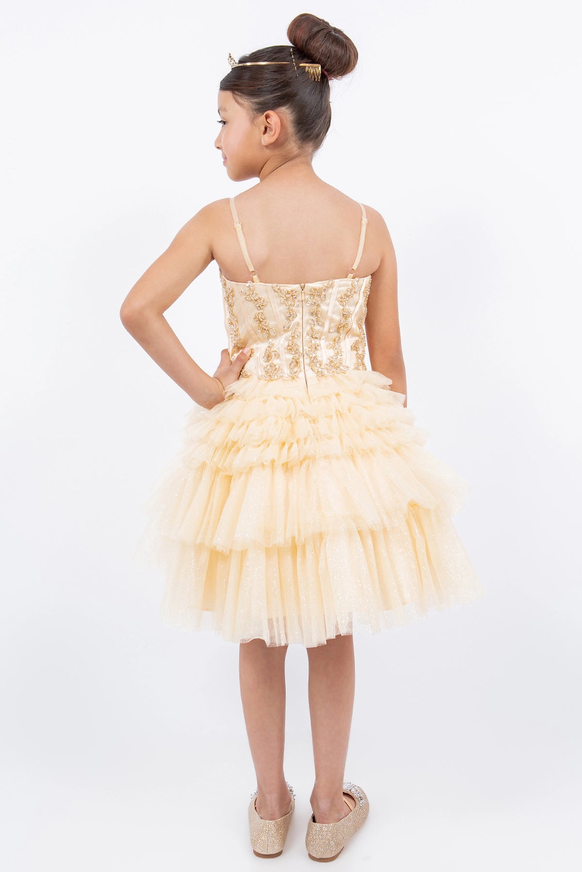 Finished details of a straight back and tiered ruffles distinguish the Champagne kids party dress.