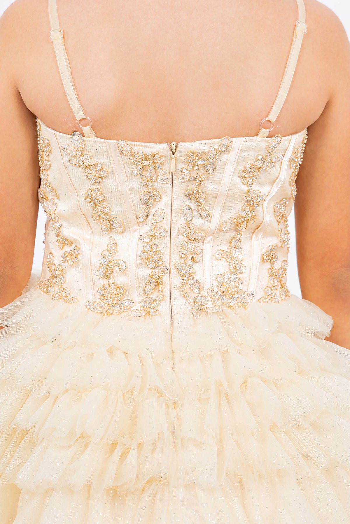Detailed by a straight back and tiered ruffles, the Champagne kids party dress reveals its construction.