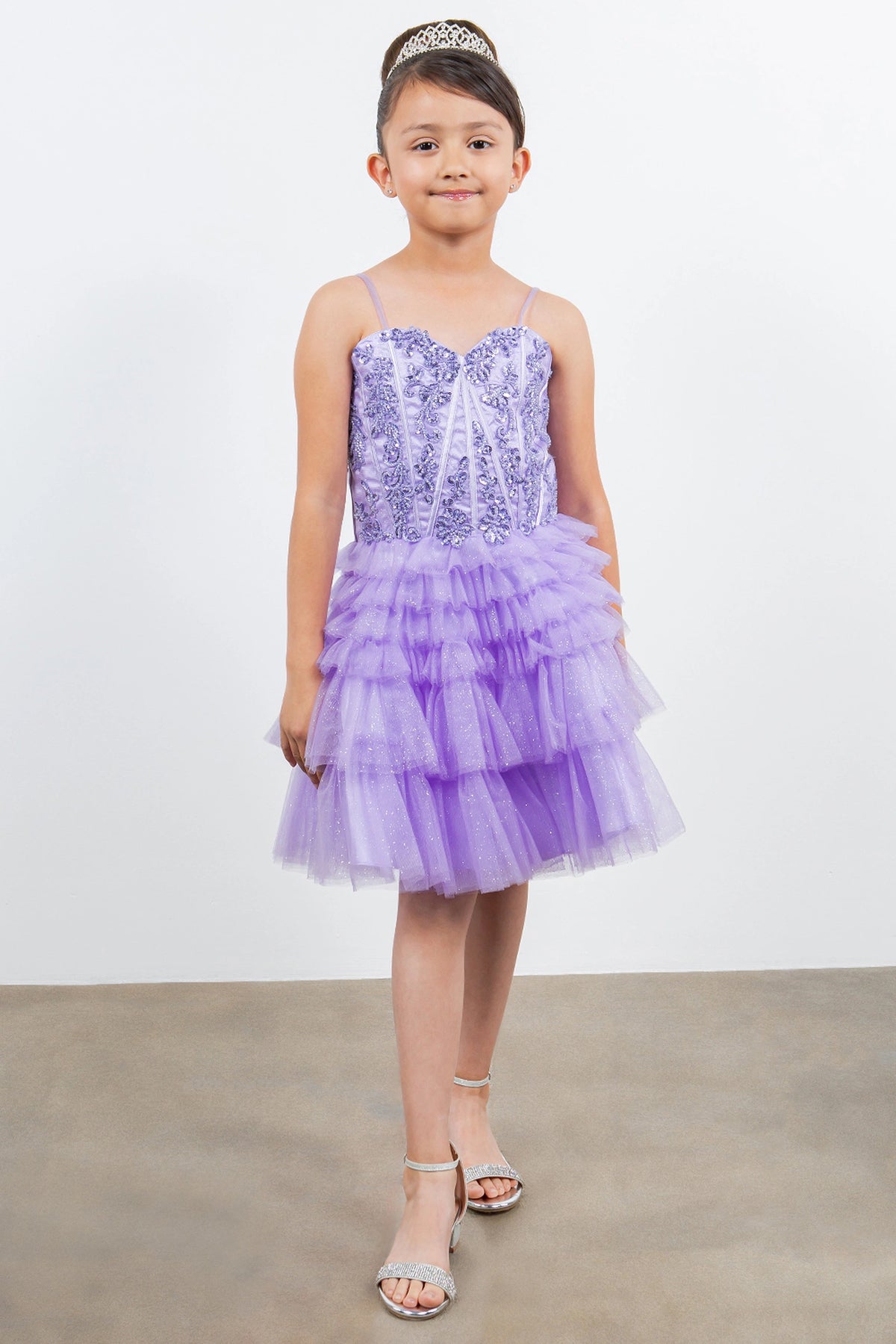 Designed details of tiered tulle ruffles distinguish the Lilac kids party dress.