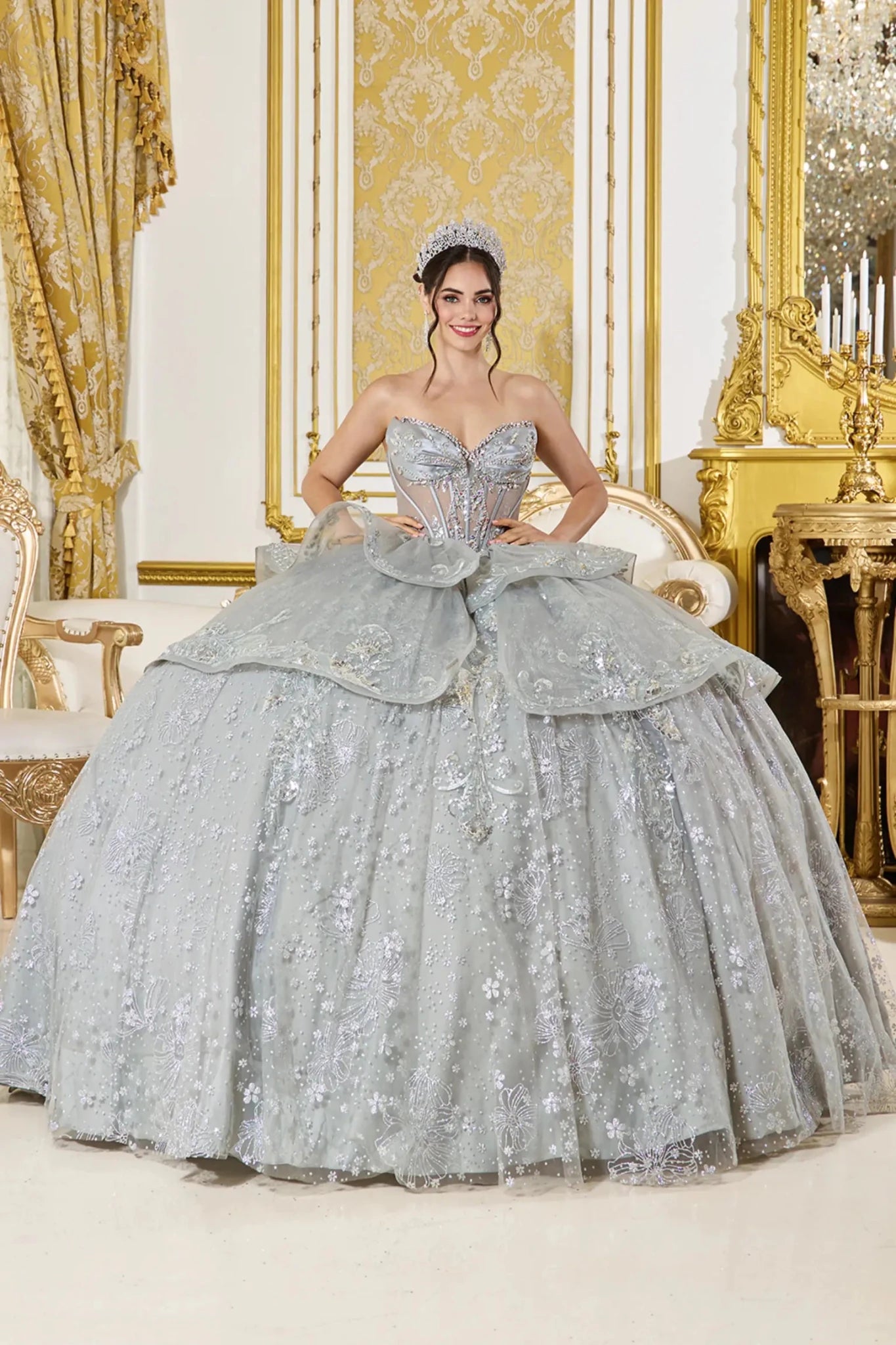 Front view of silver quinceañera ball gown with strapless sweetheart corset bodice, layered glitter tulle overskirt, and embroidered floral detailing.