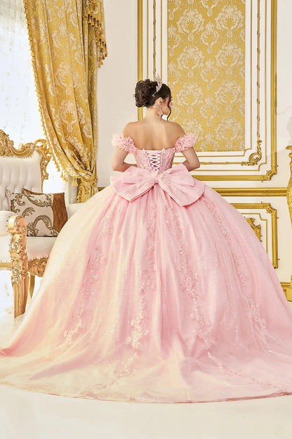 Woman standing back-facing in white ball gown with lace-up closure, off-shoulder bodice, glitter tulle layers, and cascading skirt


