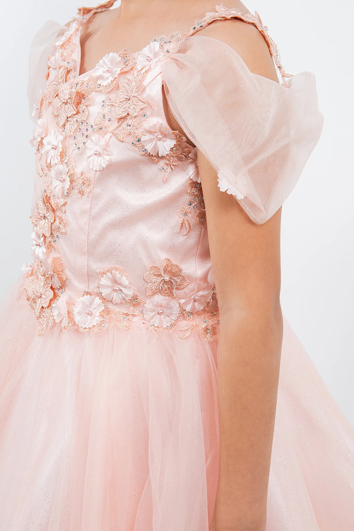 Accented dimensional flowers at the shoulders adds character to this Blush kids party dress.