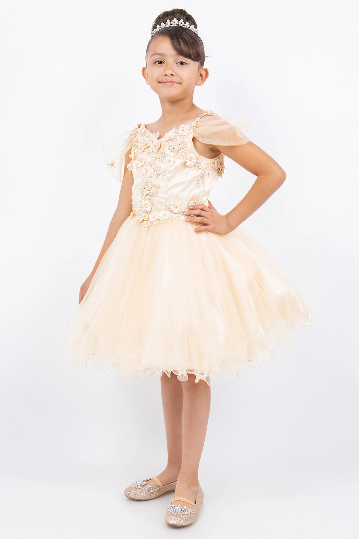 Trimmed by sheer off-shoulder straps, the Champagne kids party dress reveals its construction.