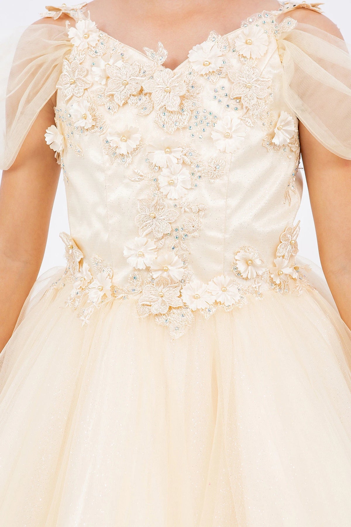 Accented dimensional flowers at the shoulders adds character to this Champagne kids party dress.