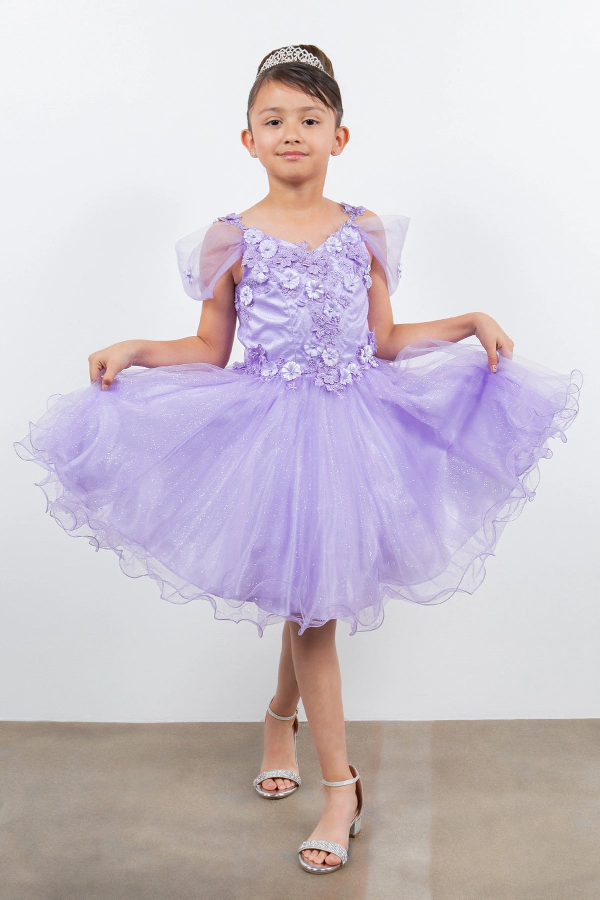 Showcasing with dimensional flowers at the shoulders, this Lavendar kids party dress displays elegant detail.