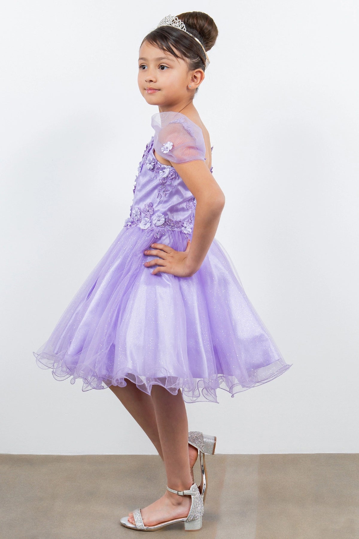 Trimmed by sheer off-shoulder straps, the Lavendar kids party dress reveals its construction.