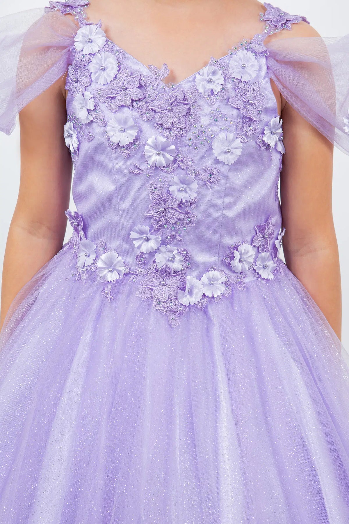 Featuring with dimensional flowers at the shoulders, this Lavendar kids party dress displays elegant detail.