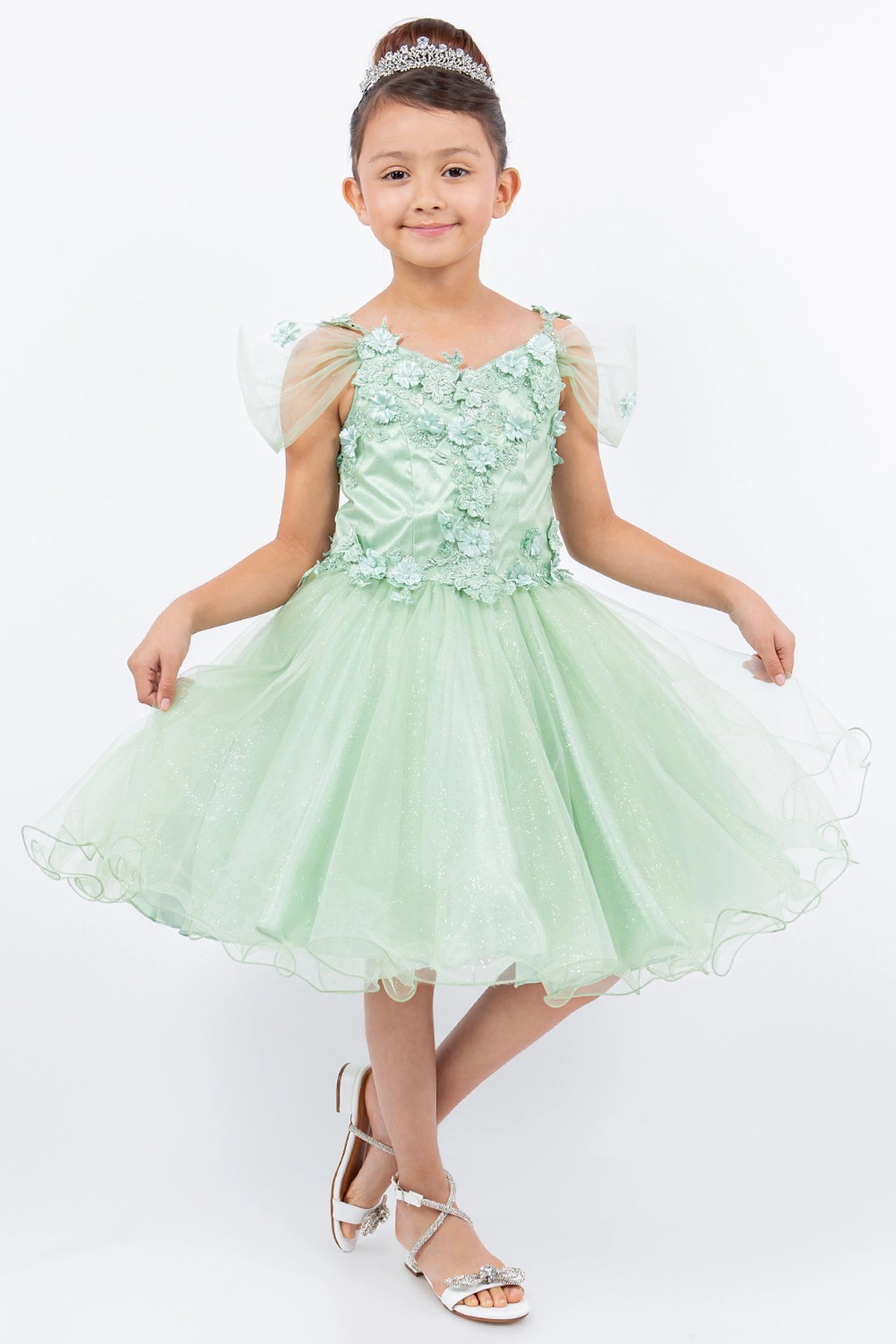 Showcasing with dimensional flowers at the shoulders, this Sage kids party dress displays elegant detail.