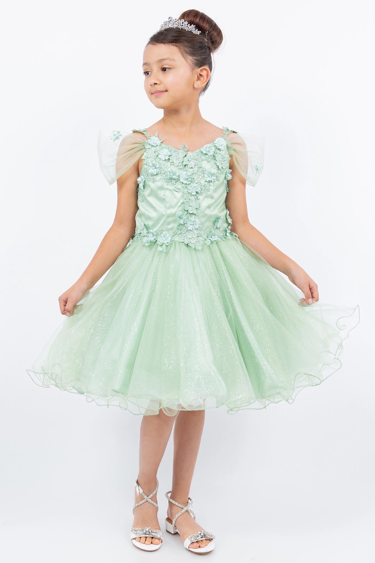 Trimmed by sheer off-shoulder straps, the Sage kids party dress reveals its construction.