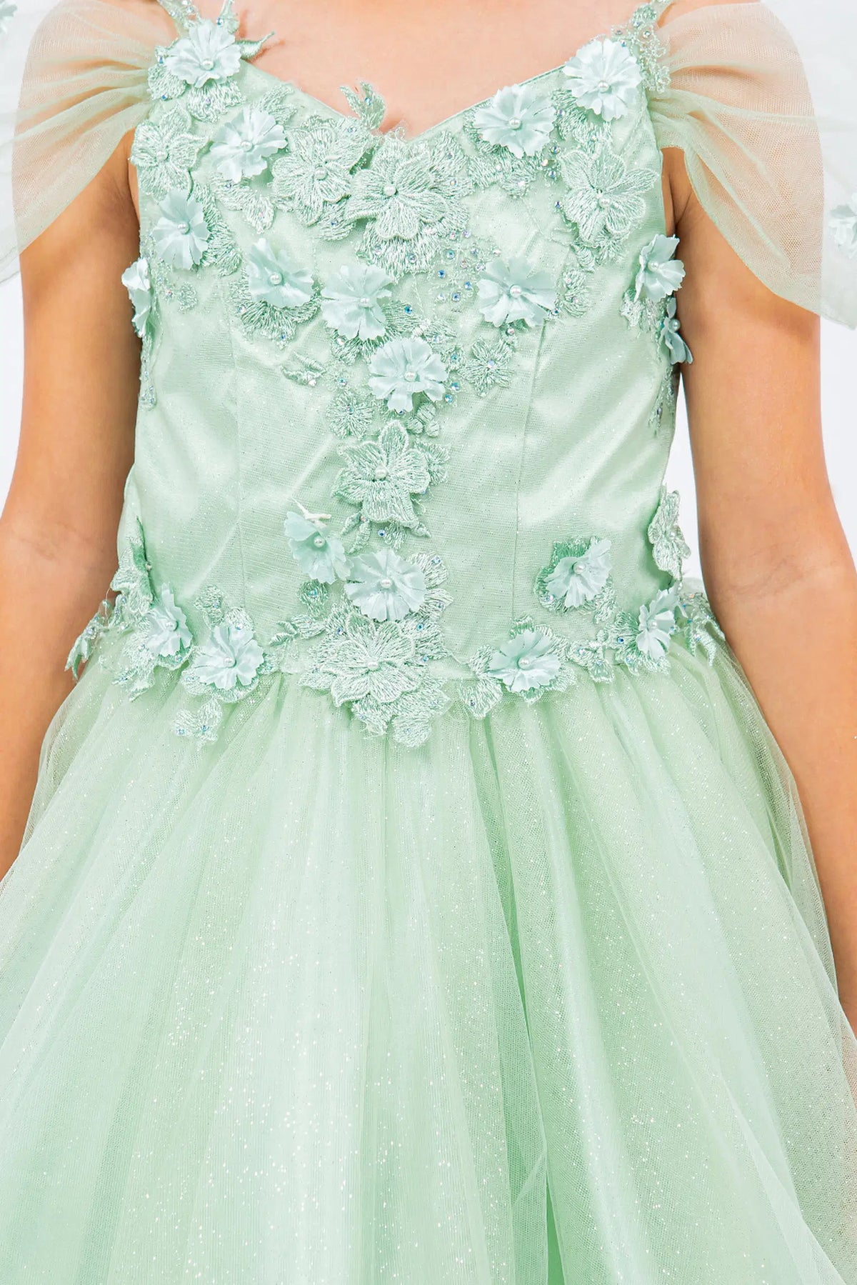Accented dimensional flowers at the shoulders adds character to this Sage kids party dress.