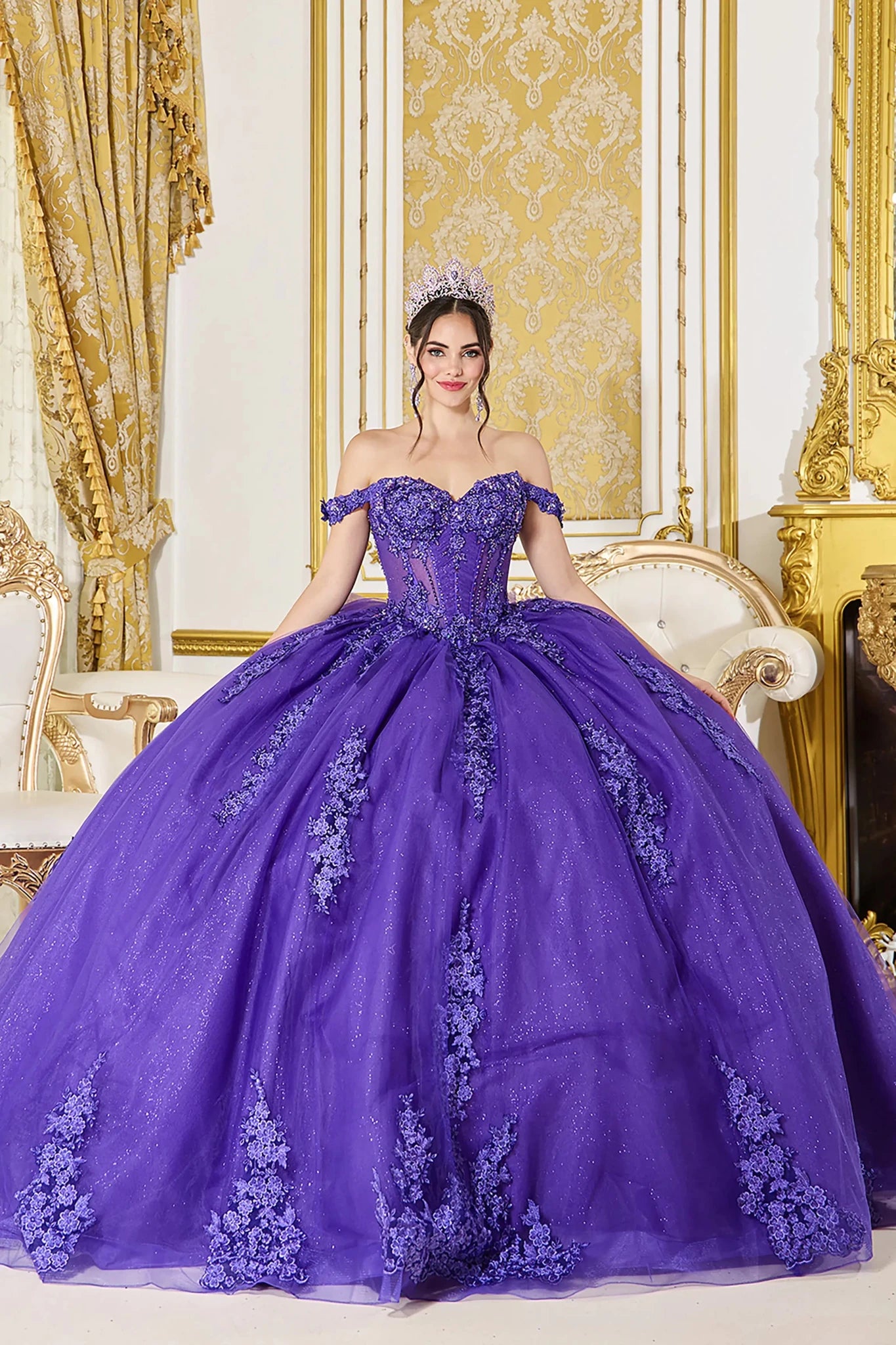 Woman in Purple off-shoulder quinceañera ball gown with lace corset and glitter tulle skirt.