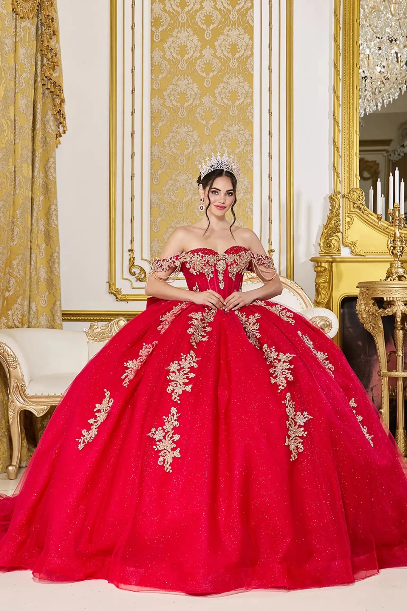 Woman wearing red off-shoulder sweetheart quinceañera dress with gold embroidered  bodice and voluminous full tulle skirt