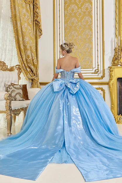 Back view of light blue quinceañera ball gown featuring a structured corset back, oversized satin bow, and long flowing train with subtle sparkle
